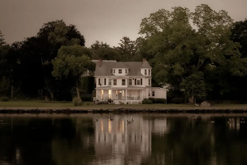 A colonial house at twilight on the Connecticut shore.